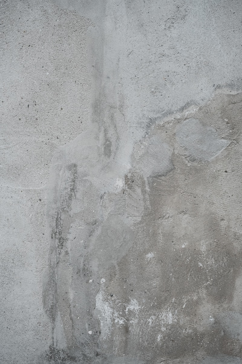 The wall shows various gray textures and stains.